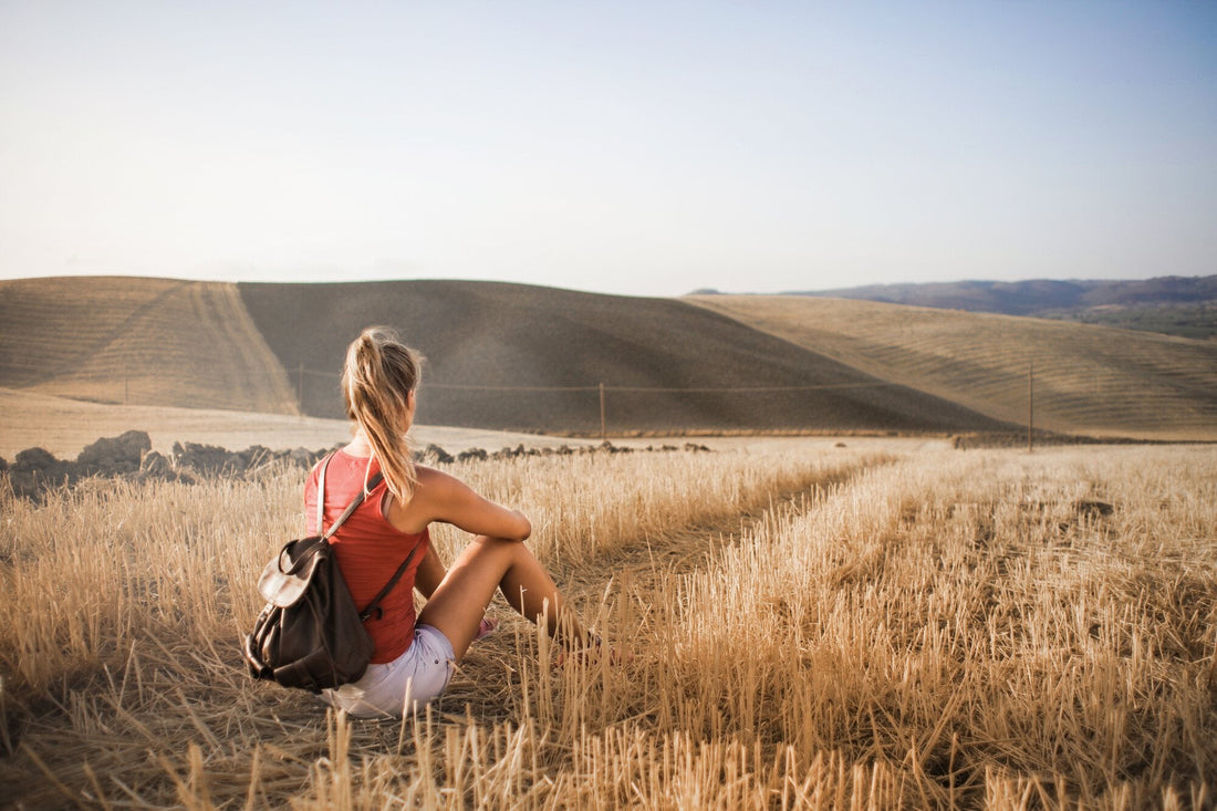 Solo traveller exploring with a backpack for Quills & Crossings